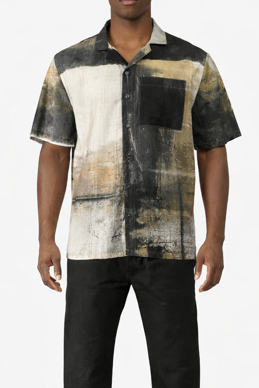 Man wearing a patterned shirt with abstract design on a white background